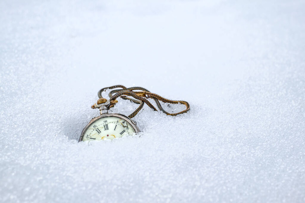 Antique rotten pocket watch, partially buried in snow - Φωτογραφία, εικόνα