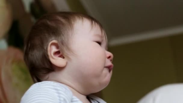 Caucasian little baby boy is offended and cries. Emotion of baby on the face, background - Filmagem, Vídeo