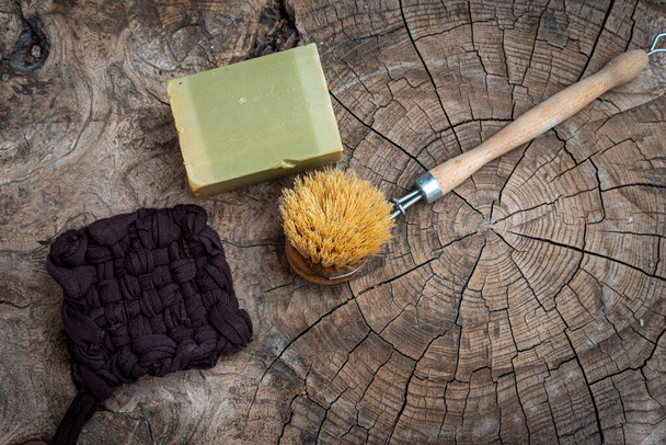scrubbung brush with olive oil soap ,aleppo or alep soap  & and handmade tawashi,on wooden table ,zero waste.; - Photo, Image