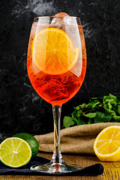 wineglass with orange wine, mint, lemon and lime. - Photo, image