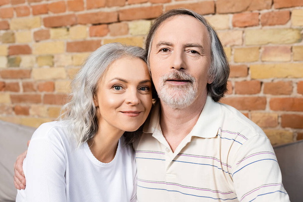 happy middle aged man and woman looking at camera  - Valokuva, kuva