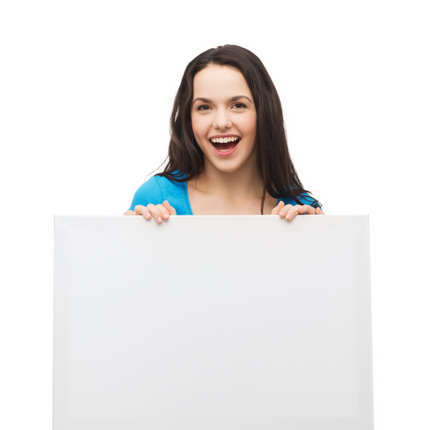 Smiling young girl with blank white board - Фото, изображение