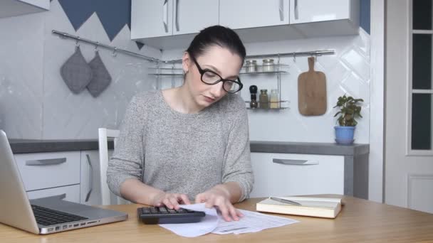 Young woman feeling stressed and upset by high taxes, bills or mortgage rate. Calculating household payments. Accountant works from home calculating bank debt invoice. - Footage, Video