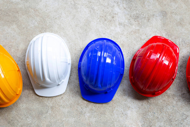 Construction helmets on concrete background. Top view - 写真・画像