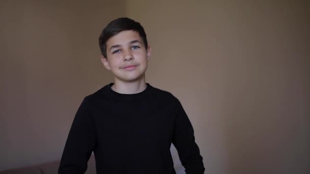 Video of young schollboy at home in black shirt. Middle selection of handsome teenage boy - Πλάνα, βίντεο