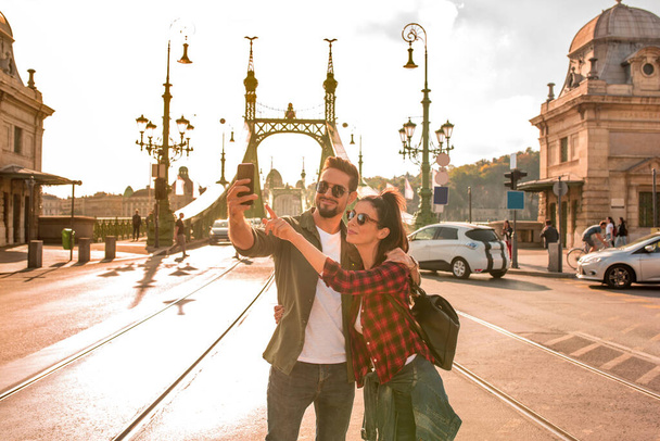 A traveling couple taking a selfie in Budapest - Фото, изображение
