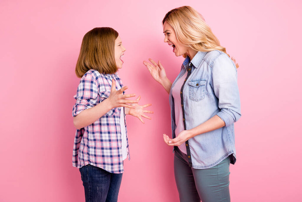 Profile side photo of anger outraged mother daughter yell shout have misunderstanding wear denim jeans checkered plaid shirt isolated over pastel color background - Zdjęcie, obraz