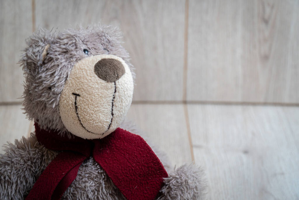 Soft teddy bear on a wooden background - Foto, Imagen