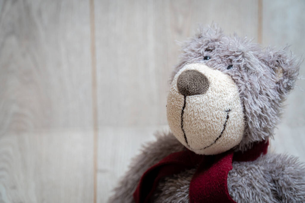 Soft teddy bear on a wooden background - Photo, Image