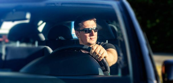 Pohledný muž řídí své auto. - Fotografie, Obrázek
