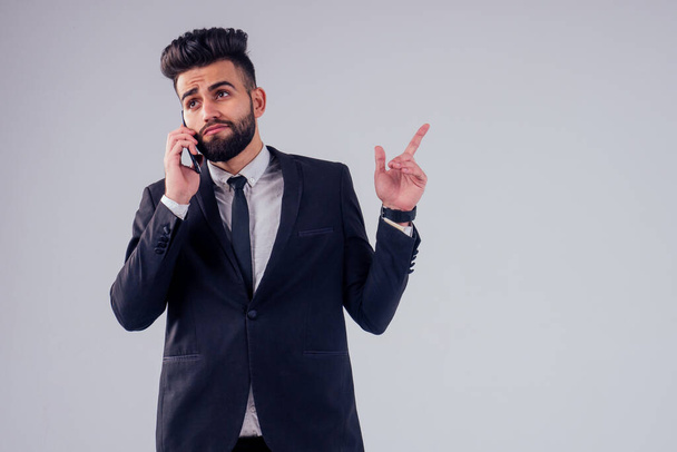 young handsome black hair man in stylish business suit in studio isolate white background - Photo, Image