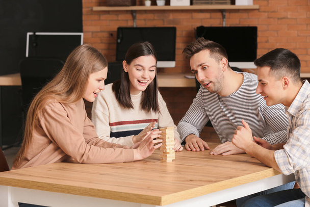 Team of business people playing jenga in office - Photo, Image