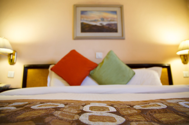 Warmly lit hotel room with shallow depth of field - Photo, Image