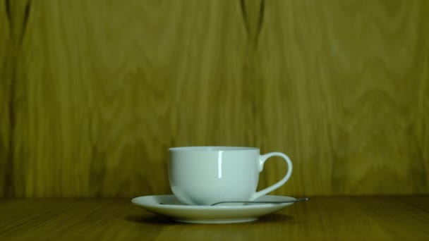 small white cup with coffee on a saucer - Footage, Video