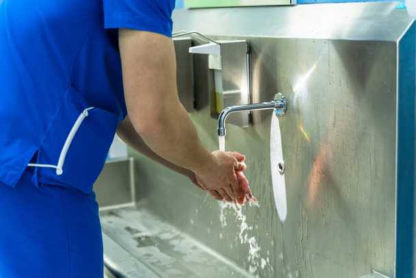Doctor washing hands. Surgeon washing hands before operating - Фото, зображення