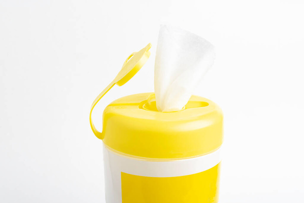 Un primer plano de una tapa superior de empuje de color amarillo abierto de un contenedor de producto de toallitas húmedas desinfectante establecido sobre fondo blanco liso
. - Foto, Imagen