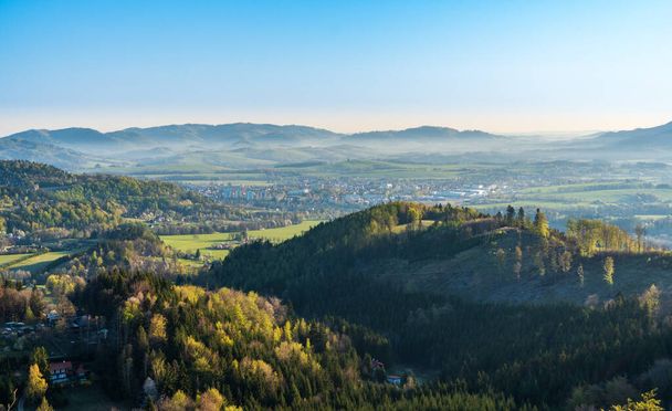 beautiful valley with village and fog in spring morning, Beskydy mountains - Photo, image