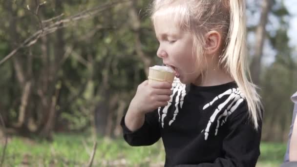 Girl in Halloween costume eats ice cream - Footage, Video