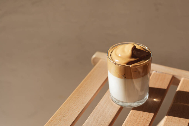 Dalgon coffee in the sunlight on a wooden bench - Fotó, kép