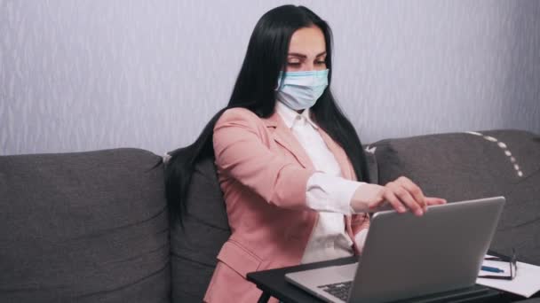 A woman uses a laptop at home in quarantine. - Materiał filmowy, wideo