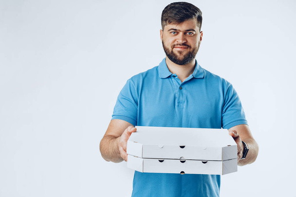 Food delivery courier with order on grey background - Foto, imagen