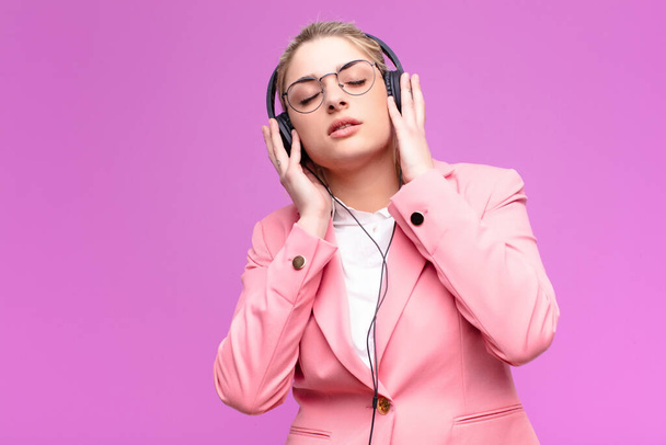 young pretty blonde woman listening music with headphones - Zdjęcie, obraz