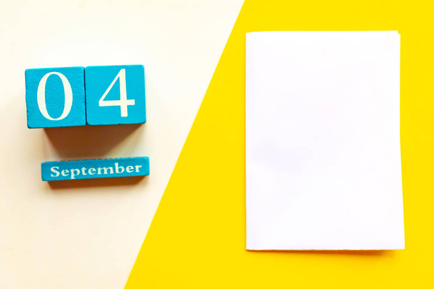 September 4, empty yellow and white geometric background. Wooden handmade calendar - Photo, Image
