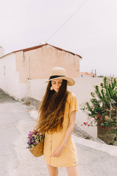 portrait of a girl in a straw hat and bag in the summer in Mediterranean, on vacation - Fotoğraf, Görsel