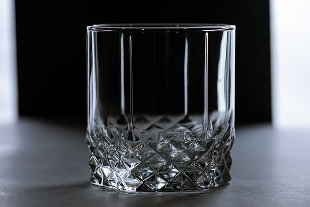 transparent glass on a dark background, low key  - Foto, Imagen