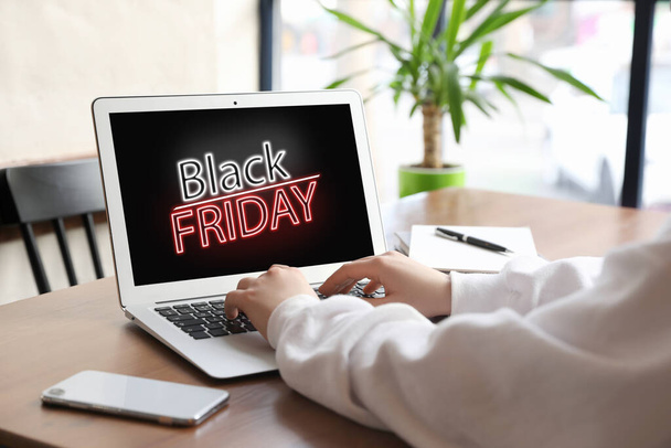 Black Friday. Woman shopping online using laptop at table, closeup - Foto, Imagem