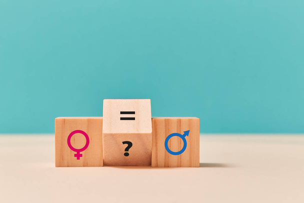 Gender, sexual equality. Human rights. Wooden cubes with feminism and masculism symbols, question mark and equal sign - Fotó, kép