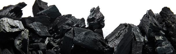 top view of black coals on white background, panoramic shot - Φωτογραφία, εικόνα