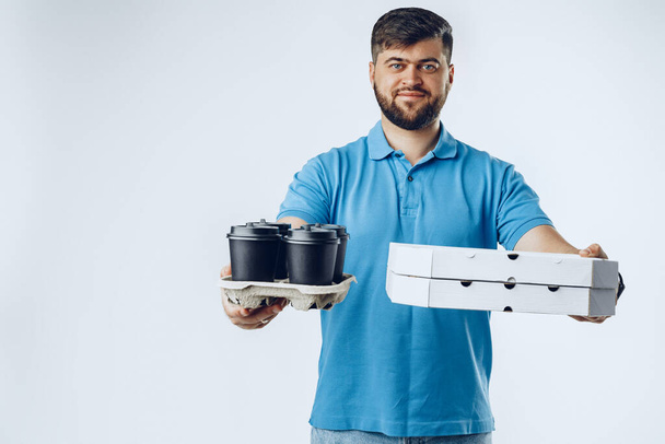 Food delivery courier with order on grey background - Foto, afbeelding