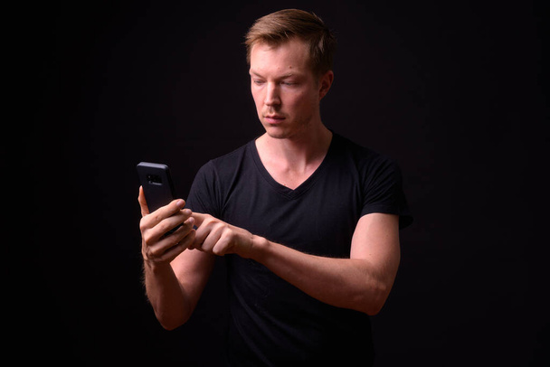Portrait of young handsome man using phone - Photo, Image