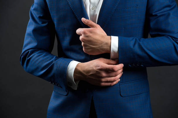 Correct sleeve length. Every detail matters. Jacket perfect fit. Business style formal dress code. Male hands adjusting business suit close up. Formal style. Business people choose formal clothing - 写真・画像