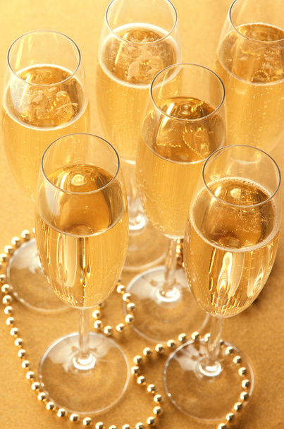 Glasses with champagne on shiny background - 写真・画像