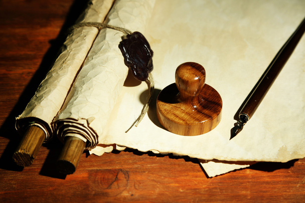 Wooden stamp, books and old papers on wooden table - Foto, Imagen