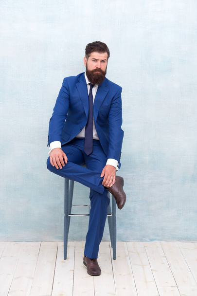 Fashion clothes shop. Classic outfit. Business leader traits. Ability to understand own strengths and weaknesses. Confident businessman sit on chair. Fashion look of manager. Formal fashion style - Photo, Image