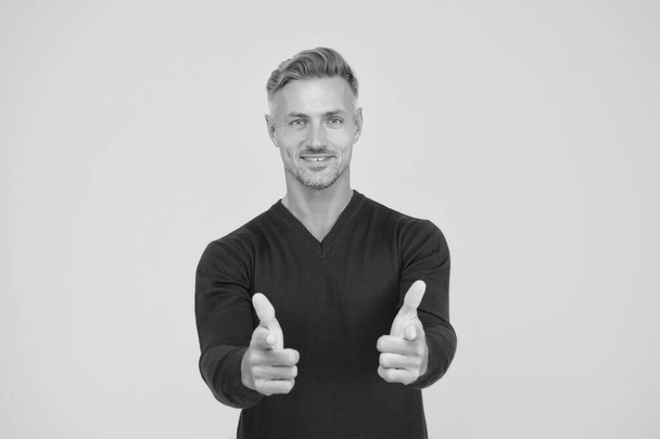 Only you. Handsome guy pointing yellow background. Happy man pointing fingers. Pointing hand gesture. Pointing straight. Finger gun or handgun. Product advertising and sale concept - Foto, afbeelding