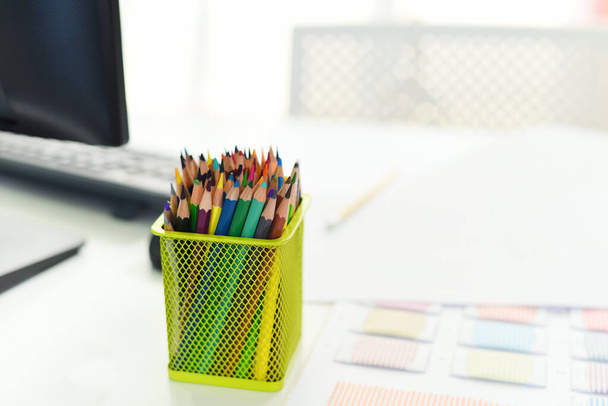 Desk in office with computer and Color pencils or Crayons colored for designer desk / Table working place business office background - Photo, Image