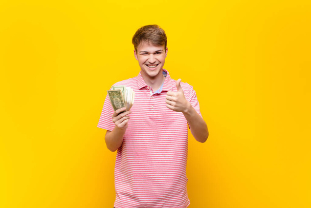 young blonde man with dollar banknotes - Фото, зображення