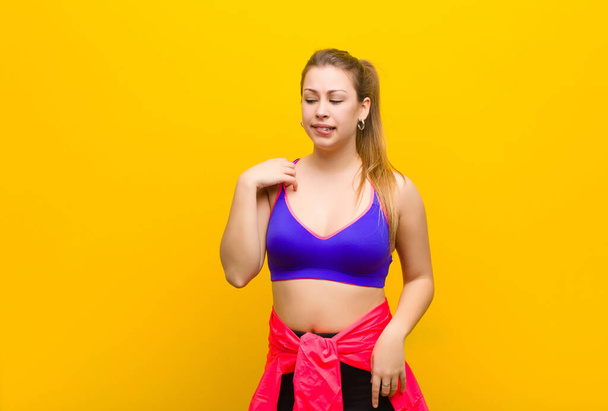 young blonde woman feeling stressed, anxious, tired and frustrated, pulling shirt neck, looking frustrated with problem. sport concept - Photo, image