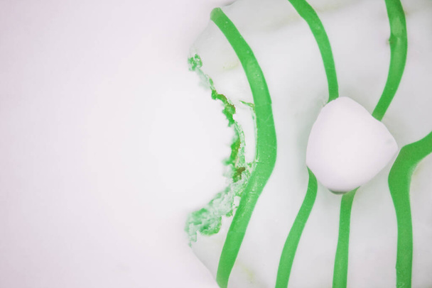 green donut top view. White background copy space - Фото, изображение
