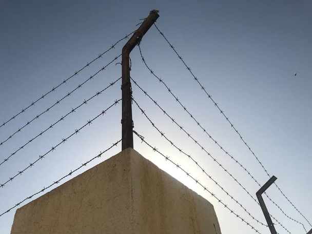 Steel barbed wire used an fencing work for more security or protection to avoid trespassers entry to zone - Photo, Image