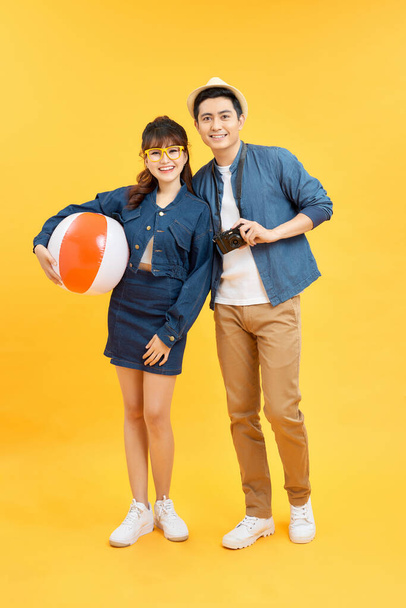Lovely Asian couple in summer casual clothes and beach accessories studio shot isolated - Foto, Imagem