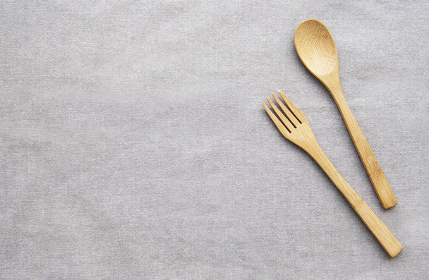 Wooden spoon and  fork on sackcloth backgrounds. Top view - 写真・画像