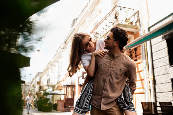 young beautiful couple have a fun and walking on city streets and drinking coffee - Foto, Imagem