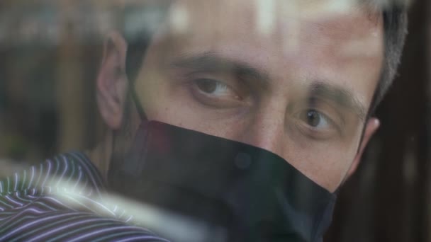 Man in face mask behind the the window - Felvétel, videó