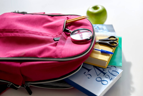 backpack with books, school supplies and apple - Fotografie, Obrázek