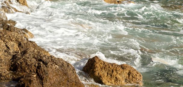 Sea wave on the stones, foamy spray, summer landscape. - Photo, Image